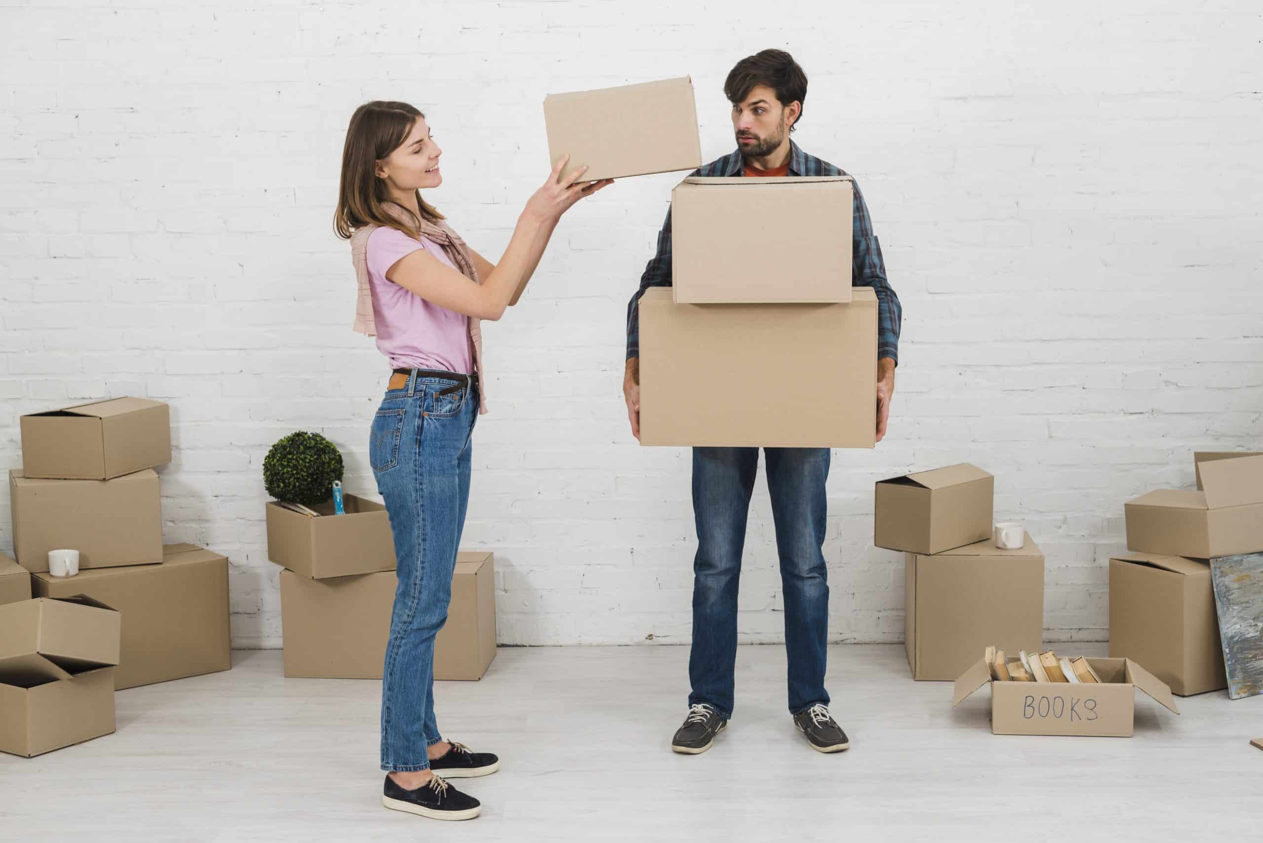 angry-man-looking-her-wife-stacking-cardboard-boxes-his-hands