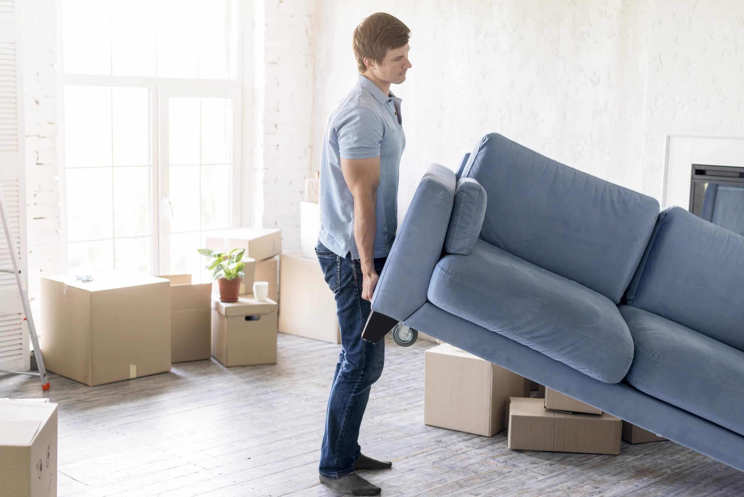 side-view-man-handling-couch-while-preparing-move-out